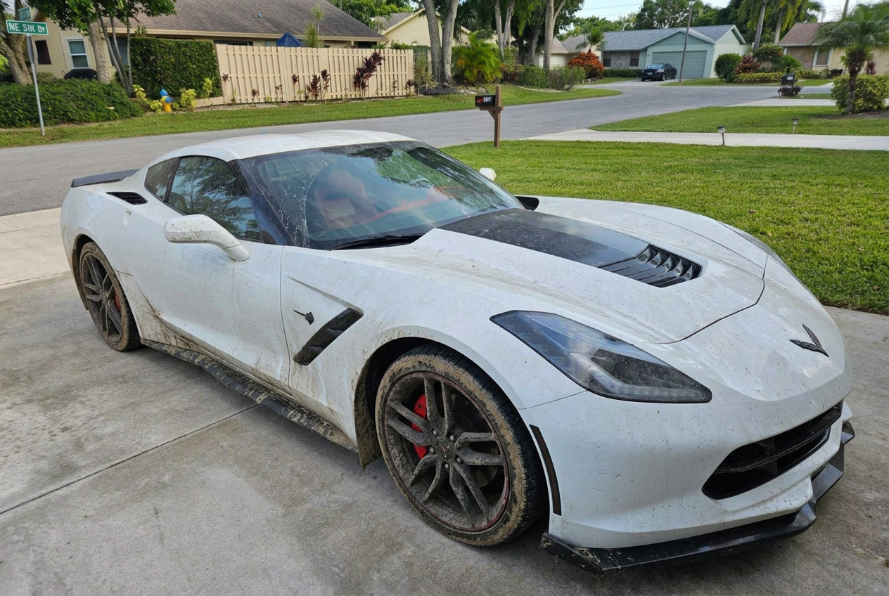 White Corvette before and after a full detail in a Boca Raton driveway - before